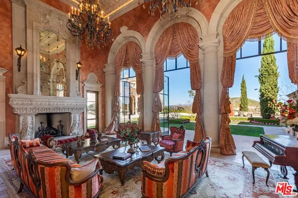 a view of a patio with couches table and chairs and potted plants