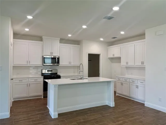 a view of kitchen with cabinets and wooden floor