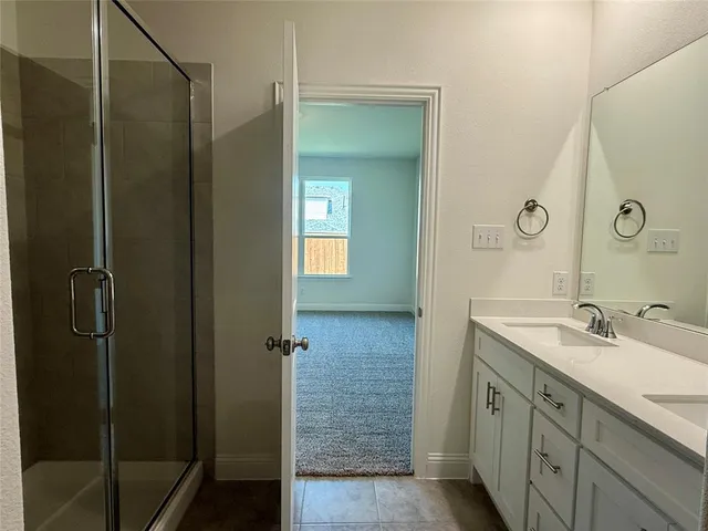 a bathroom with a double vanity sink and a mirror