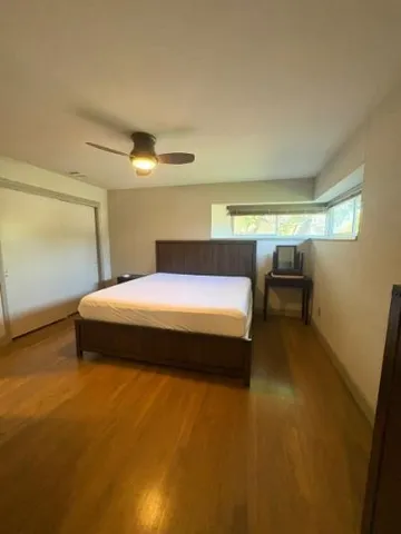 a spacious bedroom with a bed and a couch