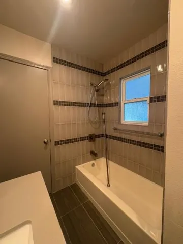 a bathroom with a bathtub and a shower