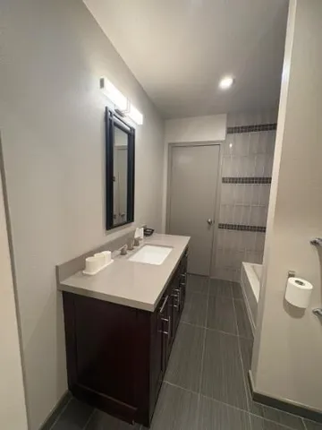 a bathroom with a sink a toilet and mirror