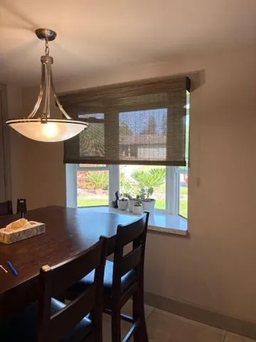 a view of a dining room with furniture and window