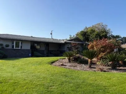 a view of a patio with table and chairs under an umbrella