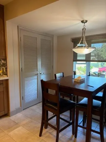 a view of a dining room a table and chairs