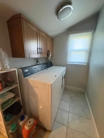 a utility room with sink dryer and washer