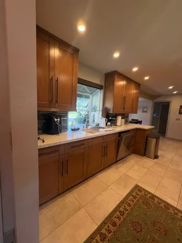 a kitchen with stainless steel appliances granite countertop a sink and cabinets