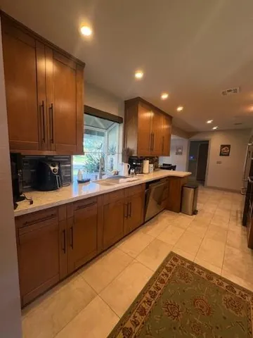 a kitchen with stainless steel appliances granite countertop a sink and cabinets