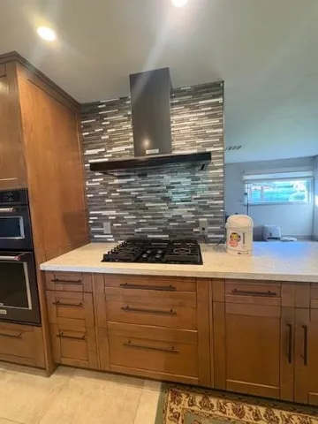 a kitchen with stainless steel appliances wooden cabinets and a counter top