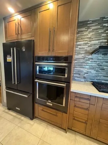 a kitchen with granite countertop cabinets and steel stainless steel appliances