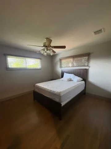 a bedroom with a bed and window