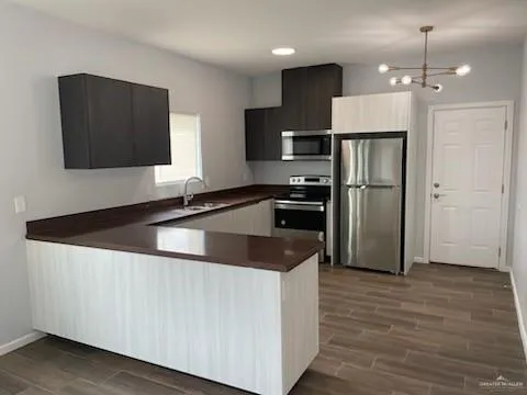a kitchen with granite countertop a refrigerator and a sink