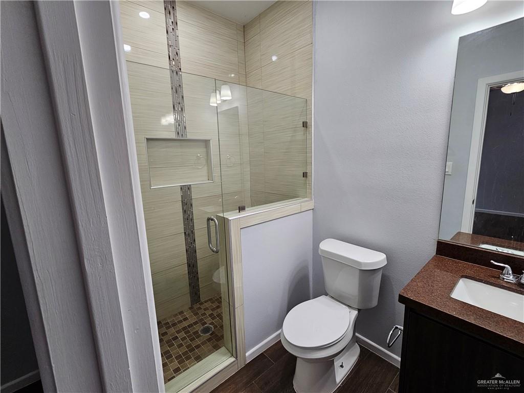 3400 Frio Avenue, Unit 1 McAllen, TX 78504 - Photo 4 of 7 a bathroom with a toilet a sink a shower and mirror