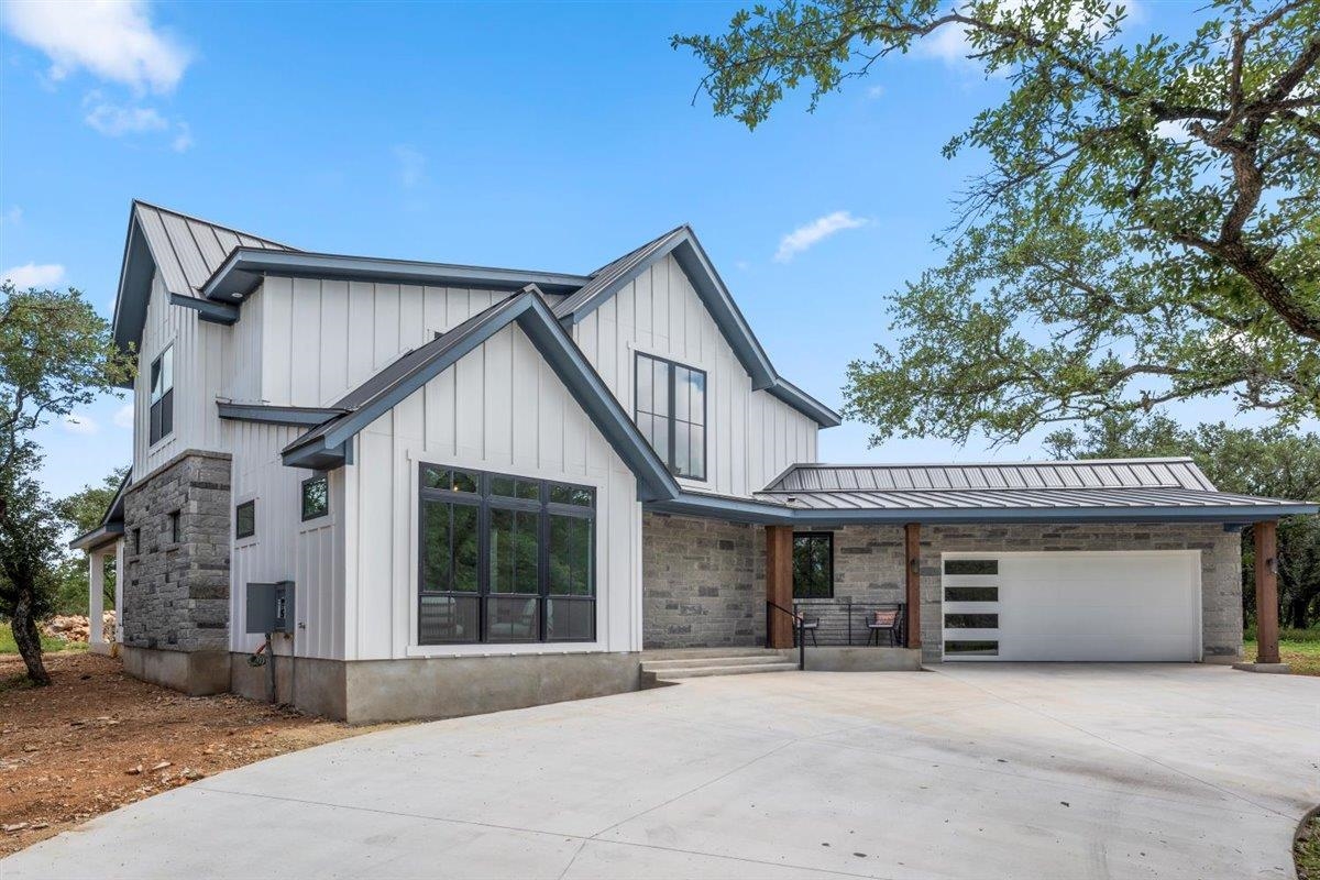 348 Lilly Lane Round Mountain, TX 78663 - Photo 1 of 1 a front view of a house with yard and parking