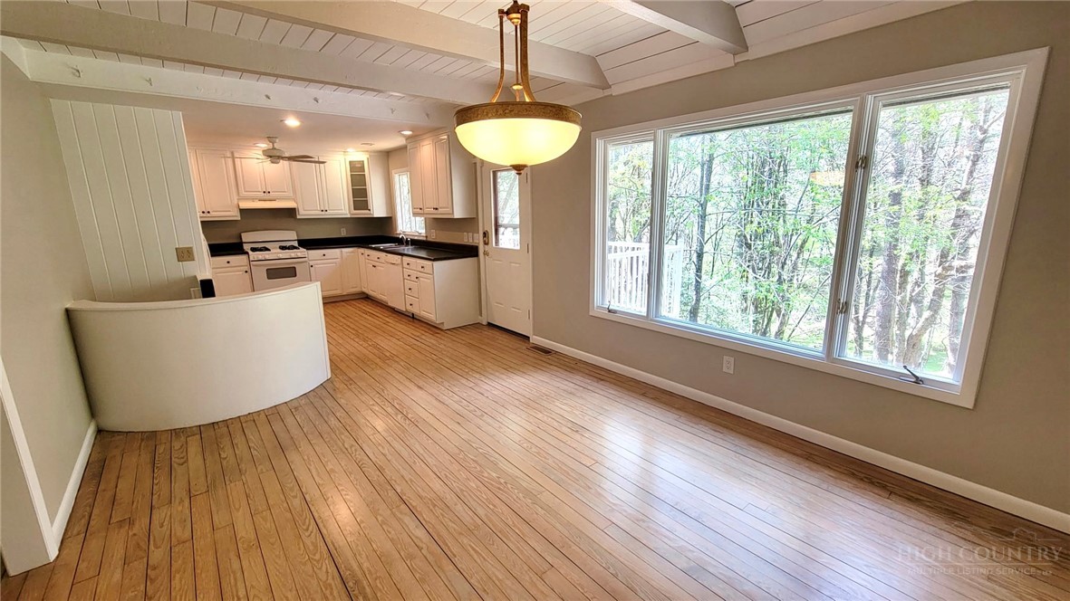 172 Yarrow Lane Boone, NC 28607 - Photo 6 of 30 a large room with wooden floor and windows