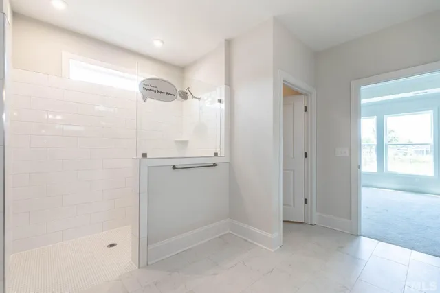 a bathroom with a shower and a glass door