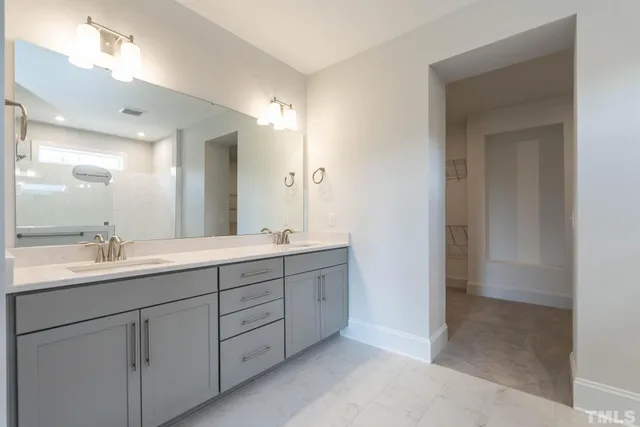 a bathroom with double sink and mirror