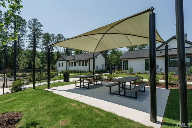 a view of a house with backyard sitting area and garden