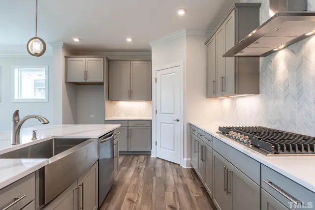 a kitchen with stainless steel appliances granite countertop a sink and a stove