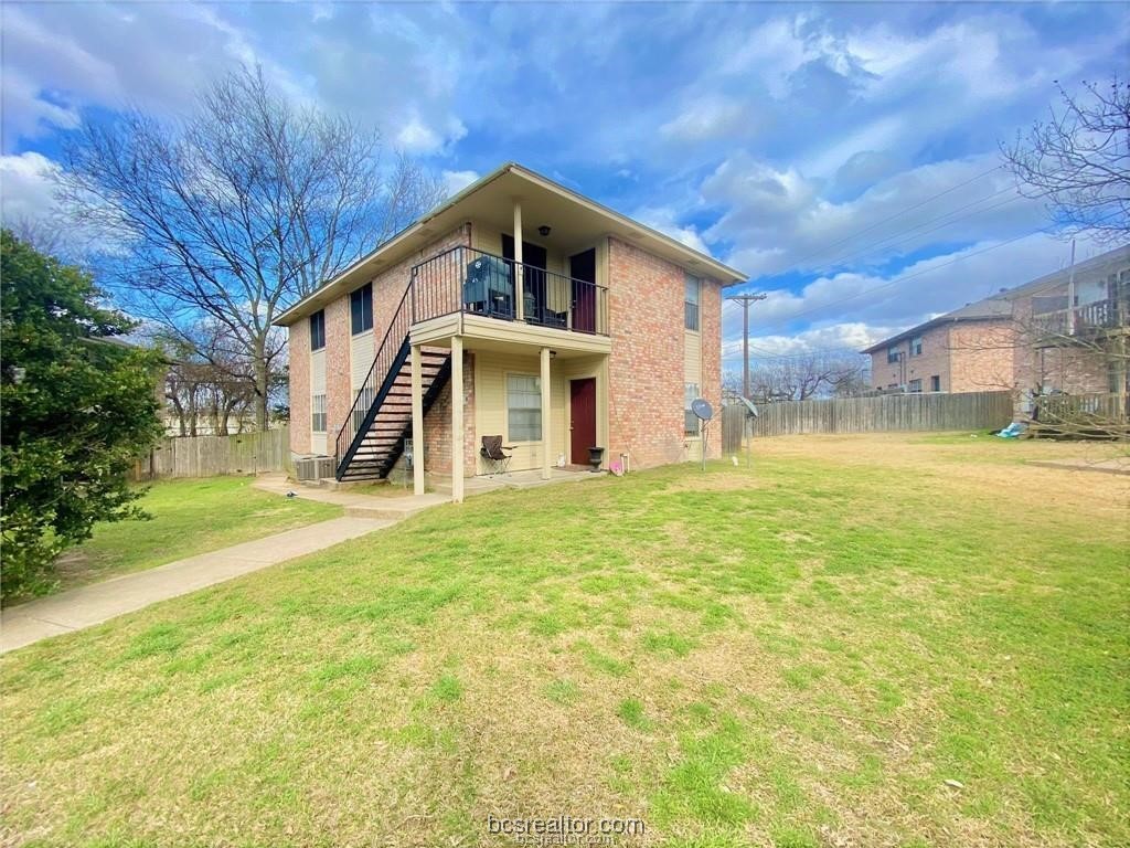 a front view of house with yard and trees