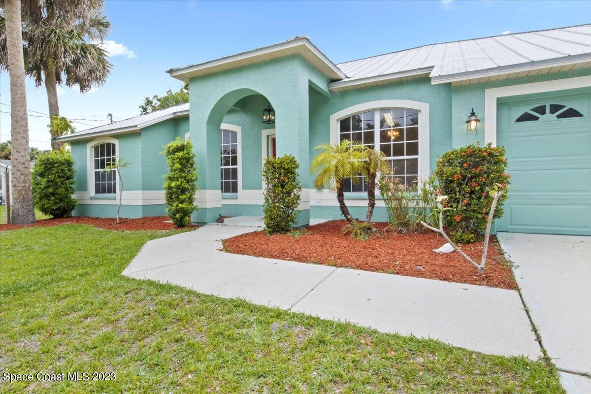 a front view of house with yard outdoor seating and barbeque oven