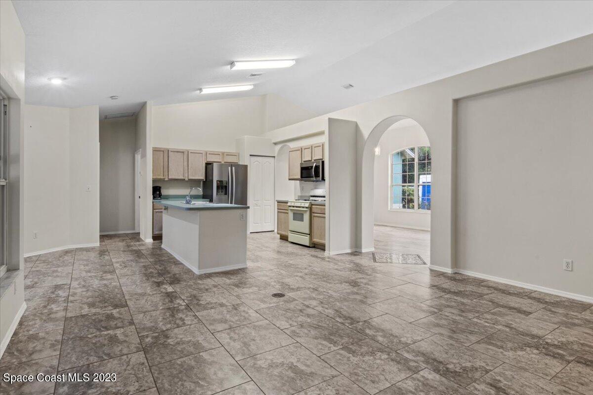2405 Ruffner Road Melbourne, FL 32901 - Photo 11 of 35 a view of a kitchen with refrigerator and window