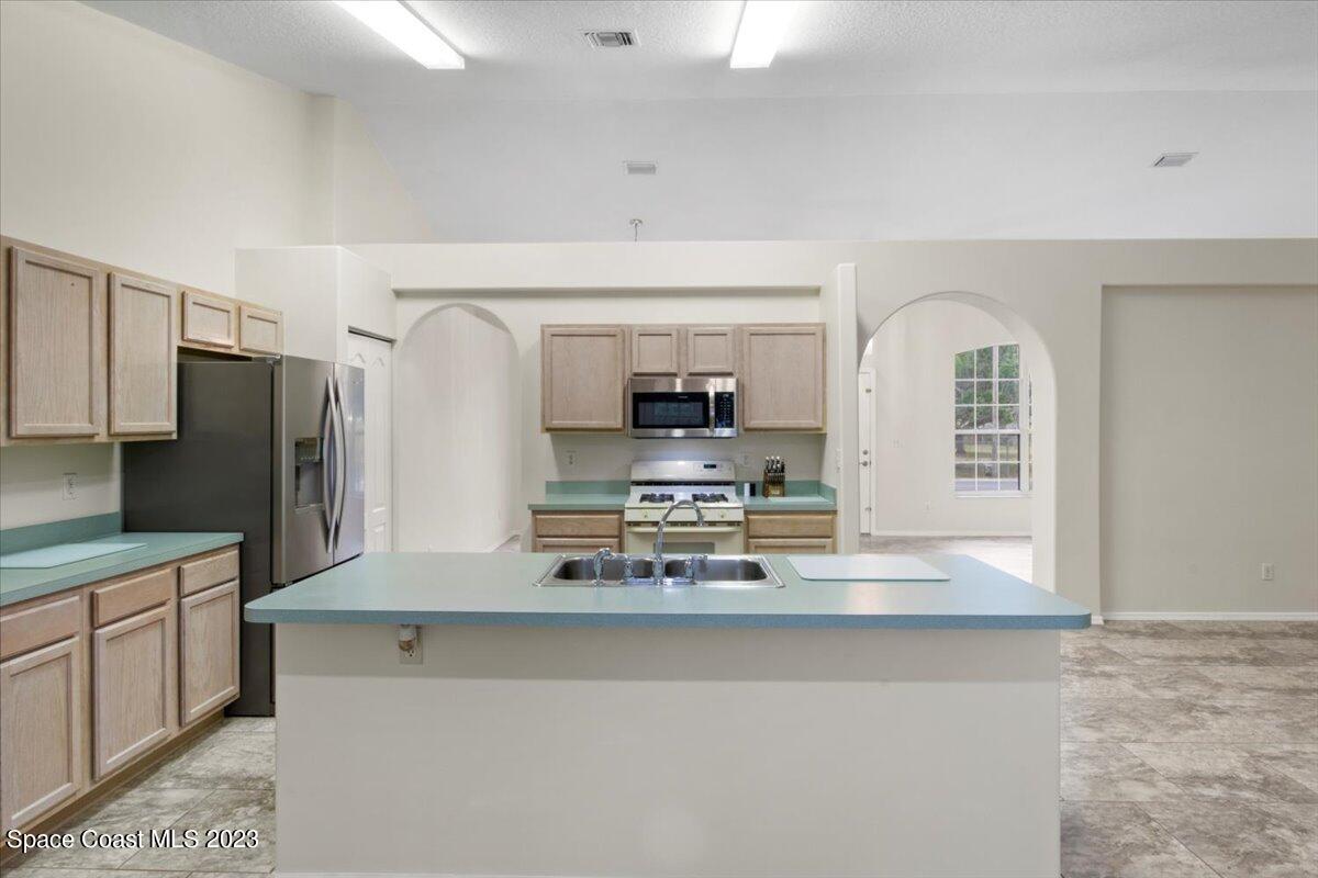 2405 Ruffner Road Melbourne, FL 32901 - Photo 13 of 35 a view of kitchen with refrigerator stove and microwave