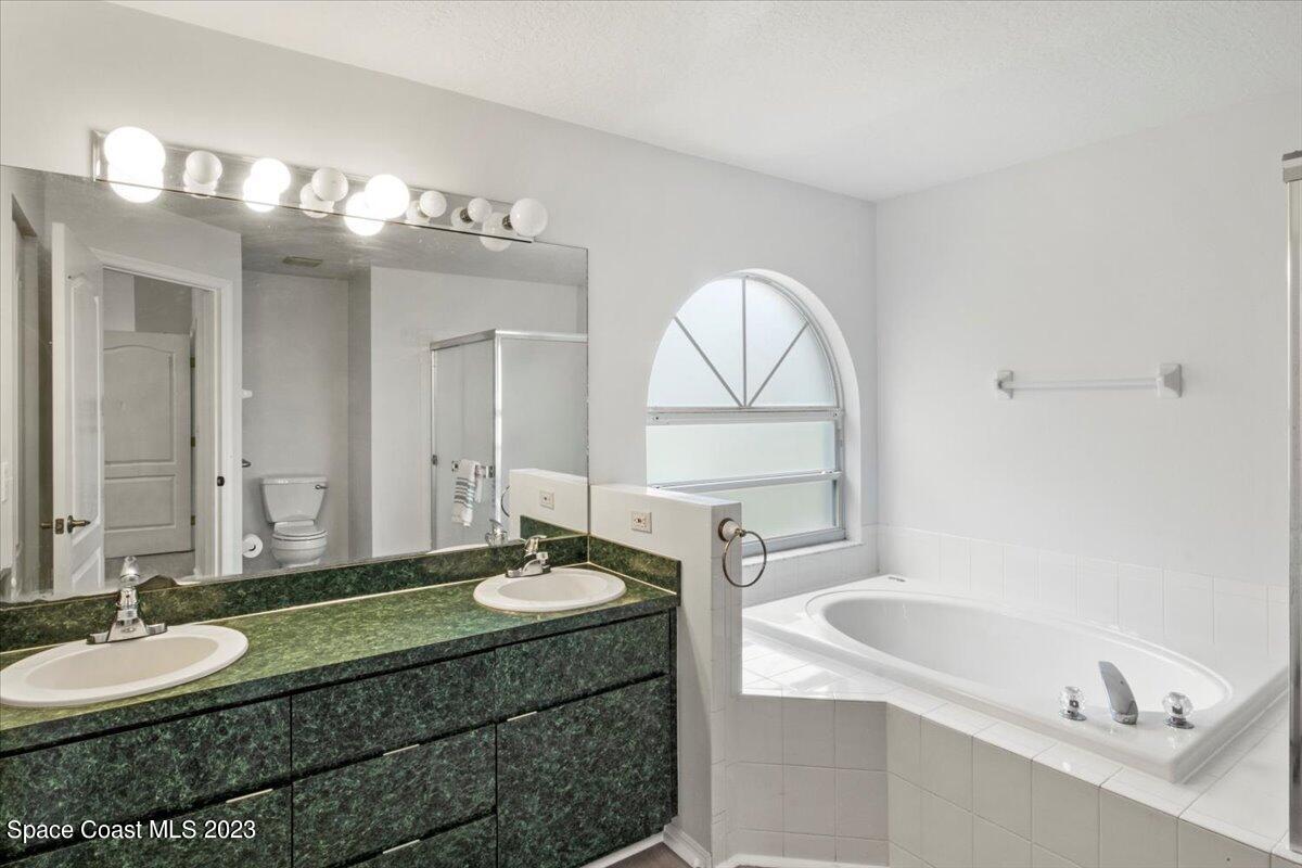 2405 Ruffner Road Melbourne, FL 32901 - Photo 19 of 35 a bathroom with a sink and a mirror