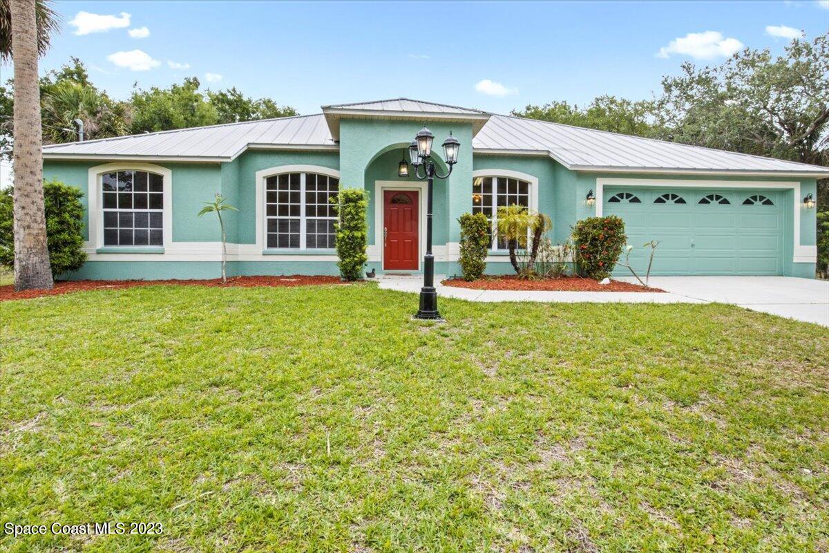 2405 Ruffner Road Melbourne, FL 32901 - Photo 2 of 35 front view of a house with a yard