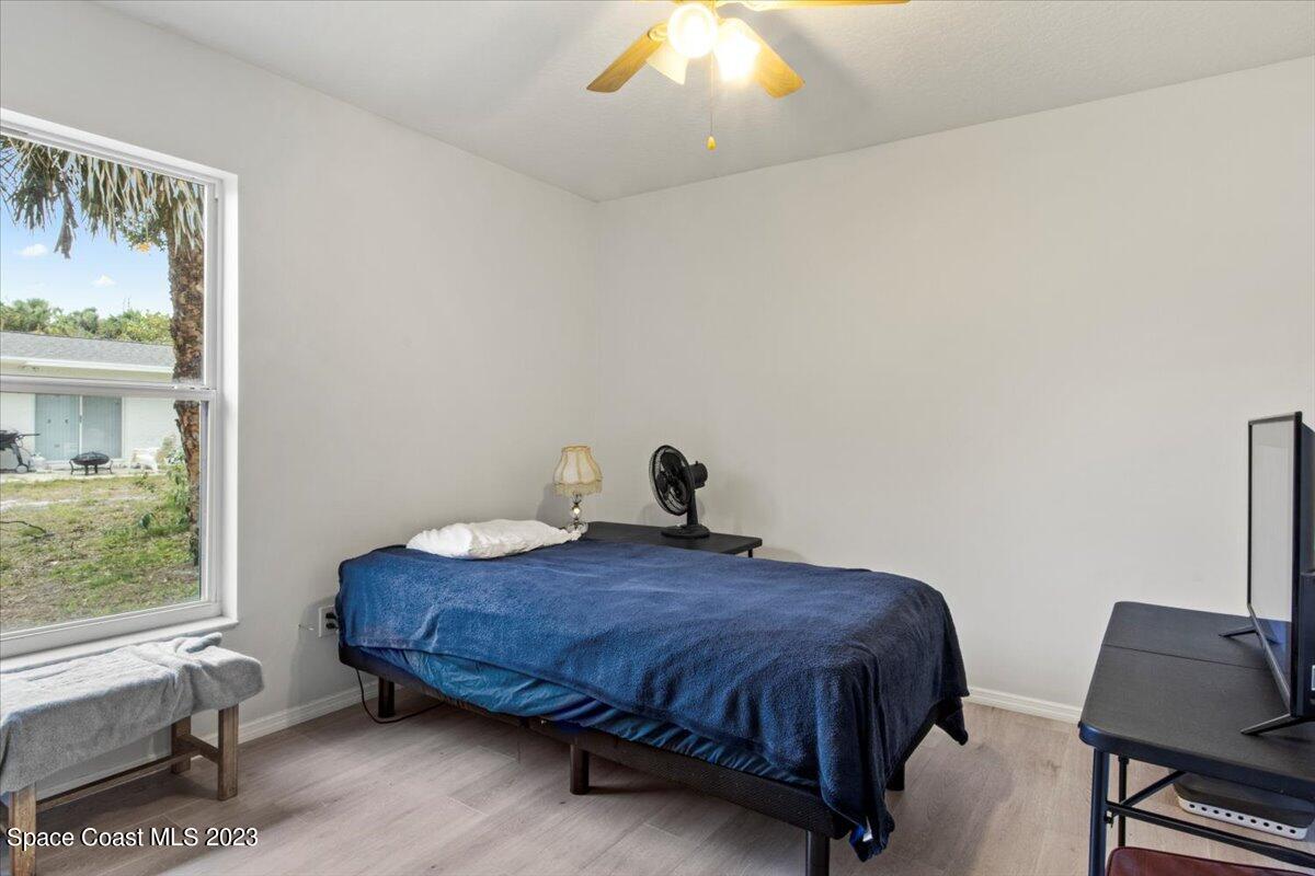 2405 Ruffner Road Melbourne, FL 32901 - Photo 25 of 35 a bedroom with a bed and chair