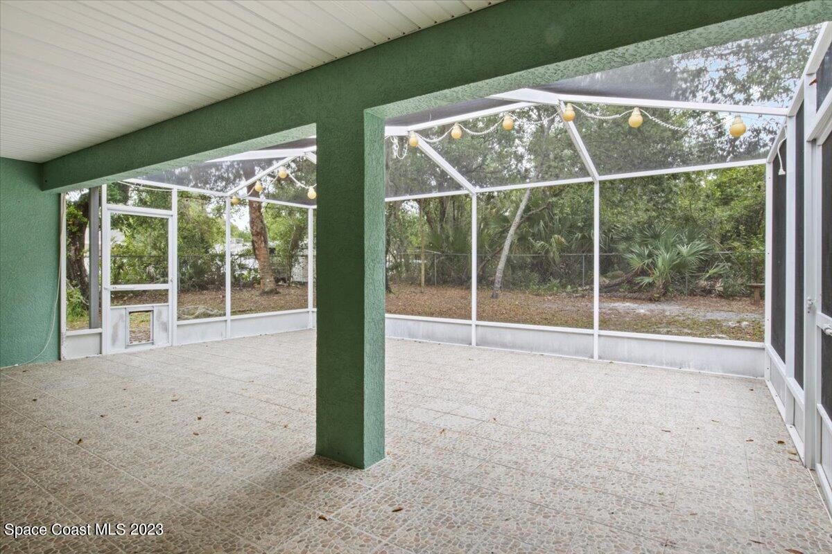 2405 Ruffner Road Melbourne, FL 32901 - Photo 27 of 35 a view of an empty room with wooden floor and a window