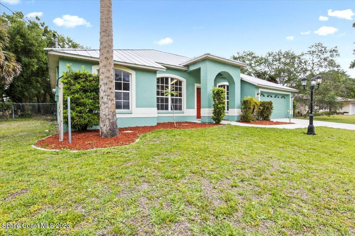 2405 Ruffner Road Melbourne, FL 32901 - Photo 3 of 35 a view of a house with a yard and large tree