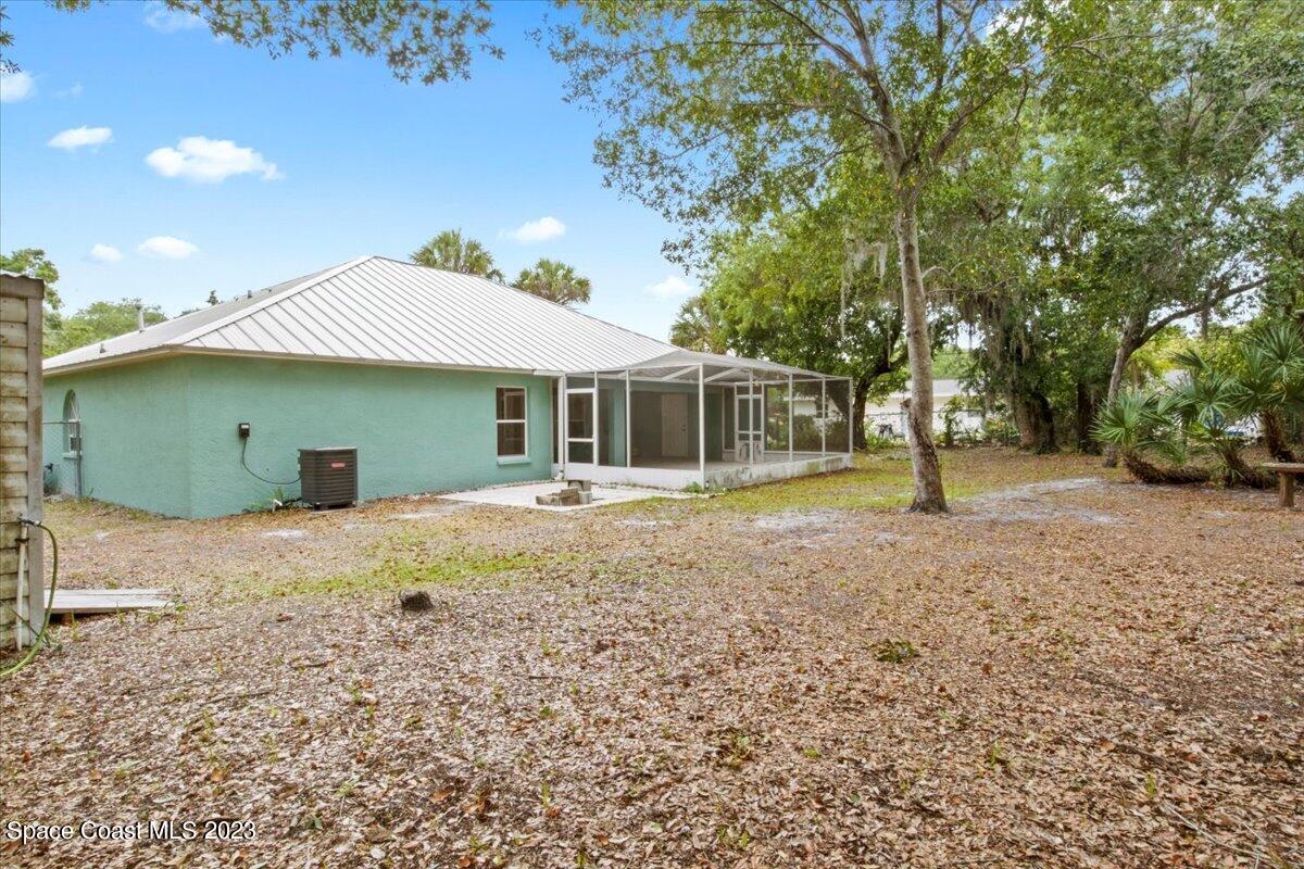 2405 Ruffner Road Melbourne, FL 32901 - Photo 31 of 35 a house with trees in the background