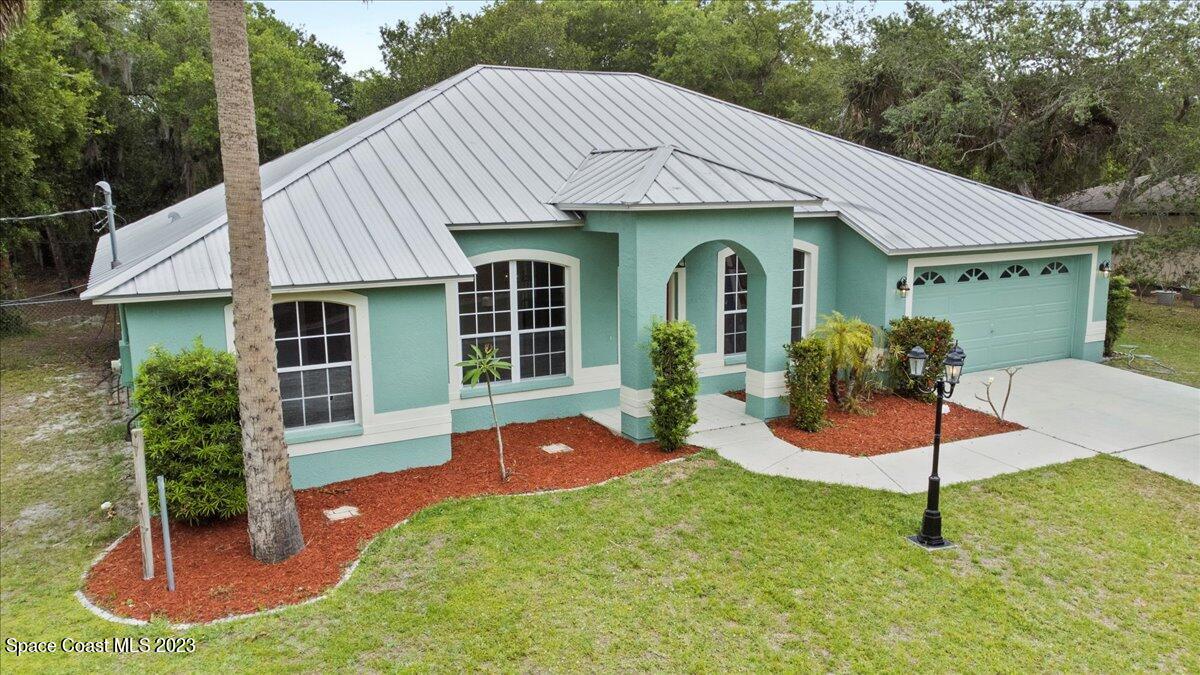 2405 Ruffner Road Melbourne, FL 32901 - Photo 35 of 35 a view of a house with a yard potted plants and a table