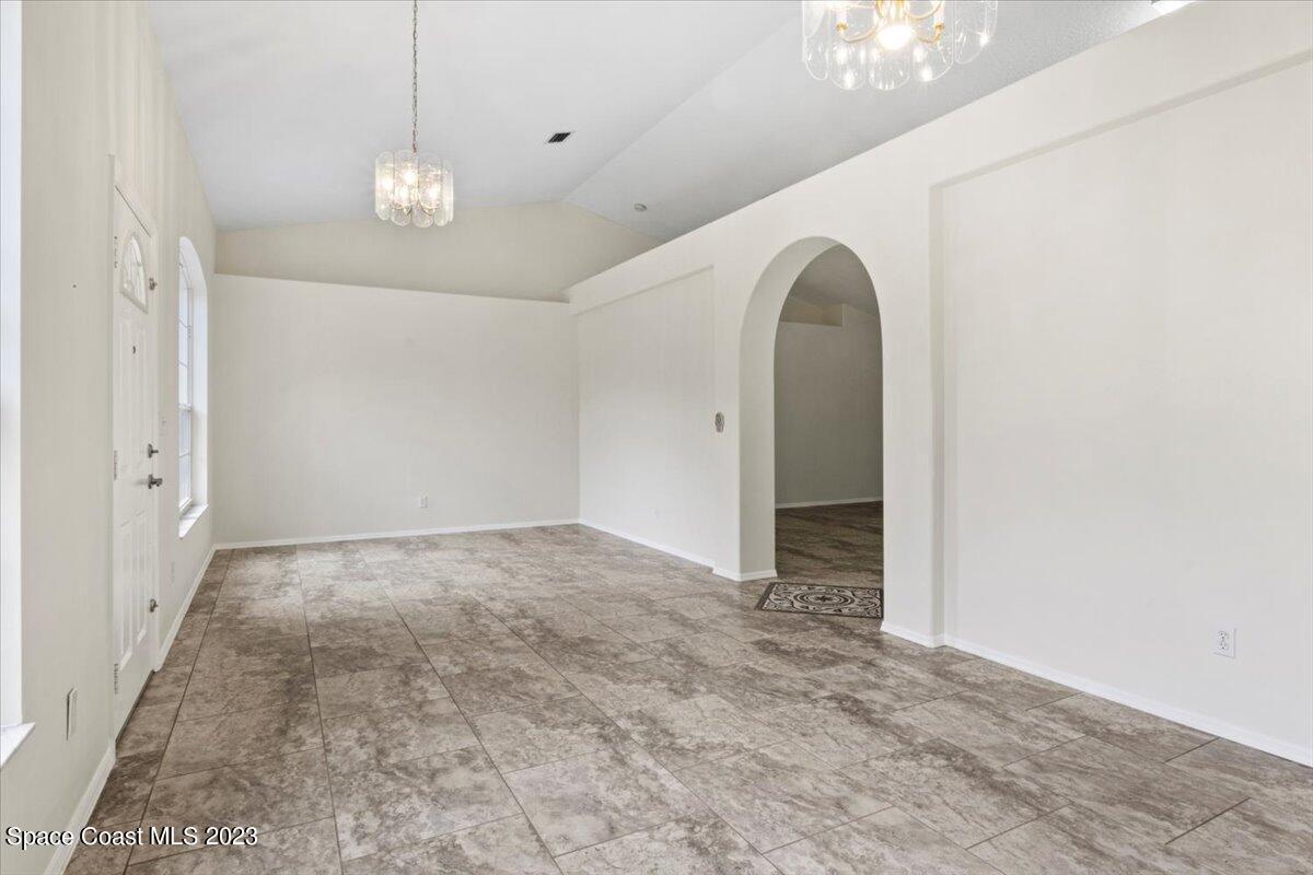 2405 Ruffner Road Melbourne, FL 32901 - Photo 4 of 35 a view of a room with wooden floor and chandelier