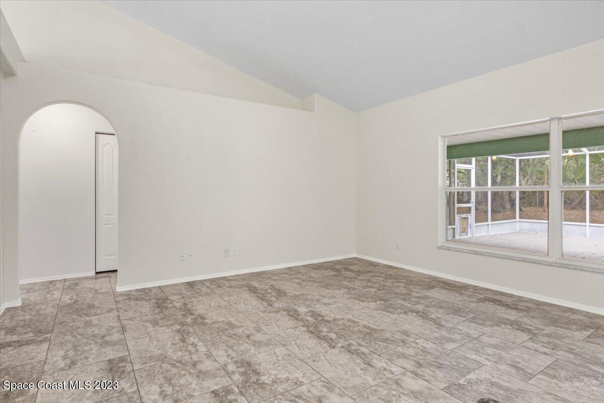 2405 Ruffner Road Melbourne, FL 32901 - Photo 9 of 35 an empty room with windows