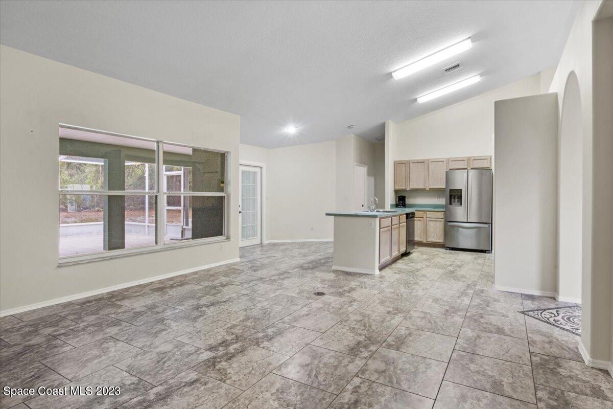 2405 Ruffner Road Melbourne, FL 32901 - Photo 10 of 35 a view of kitchen with refrigerator and window