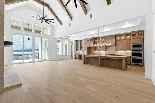 a large white kitchen with a large window