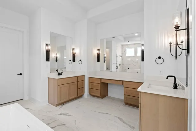 a large bathroom with a double vanity sink mirror and bathtub