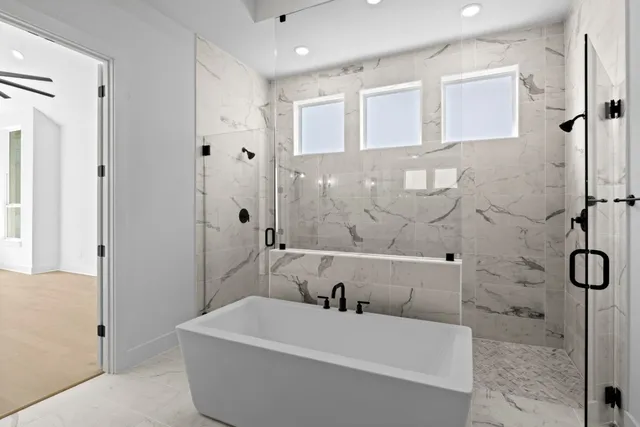 a bathroom with a bathtub and shower
