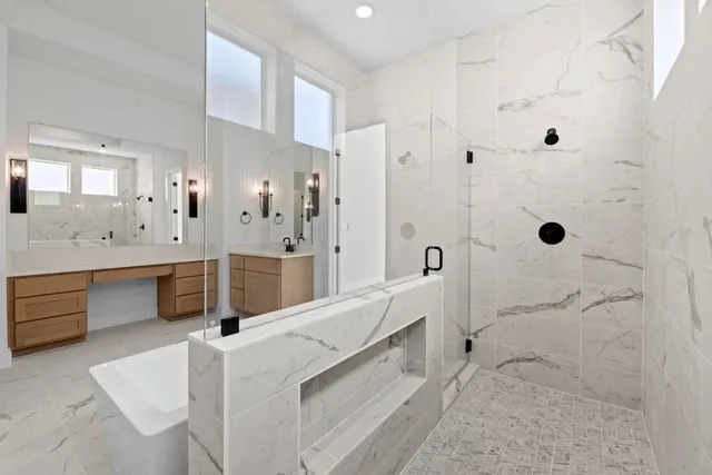 a large white bathroom with a double vanity sink a large mirror and shower