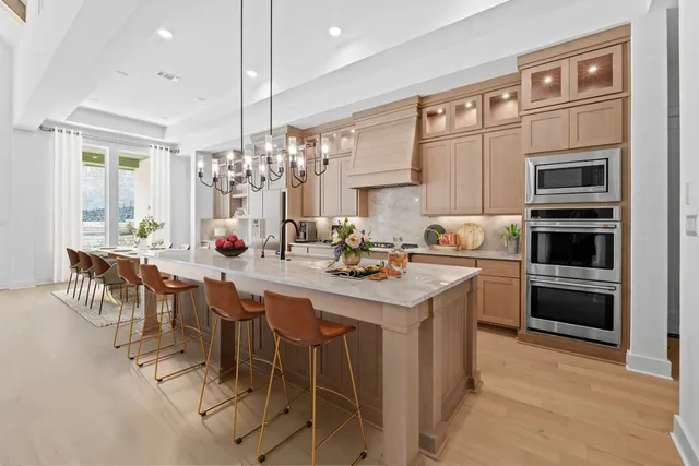a kitchen with stainless steel appliances kitchen island granite countertop a sink and cabinets