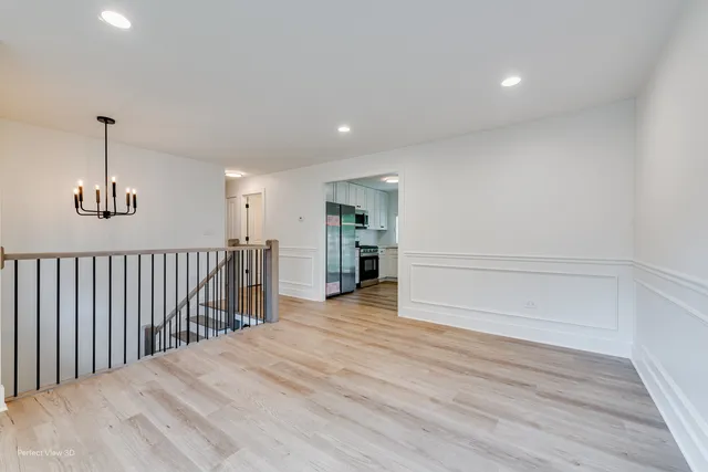 a view of a room with wooden floor stairs and a window