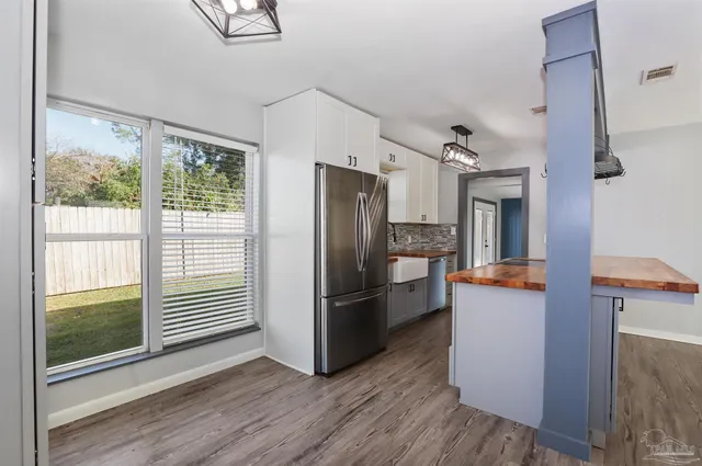 a kitchen with stainless steel appliances a refrigerator and a stove