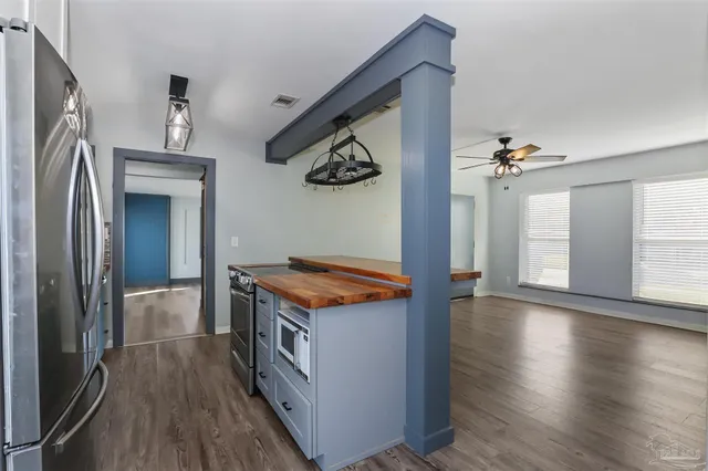 a kitchen with stainless steel appliances granite countertop a stove and a refrigerator