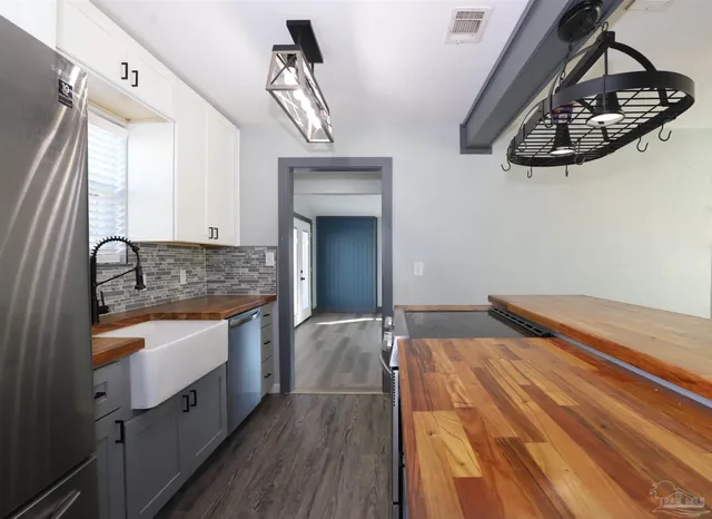 a spacious bedroom with a sink and dresser