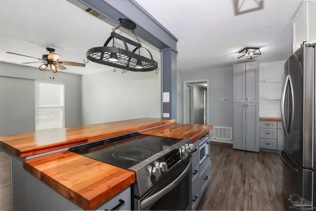 a blue bed sitting in a kitchen next to a window