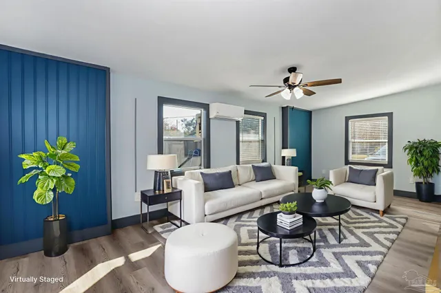a living room with furniture a chandelier and a window