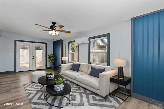 a living room with furniture and wooden floor