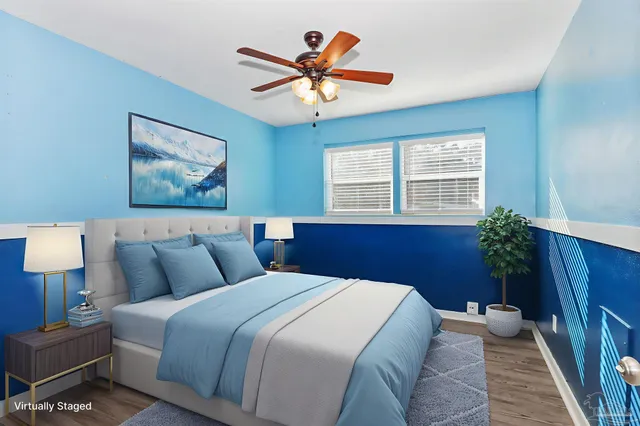 a bedroom with a large bed and a chandelier